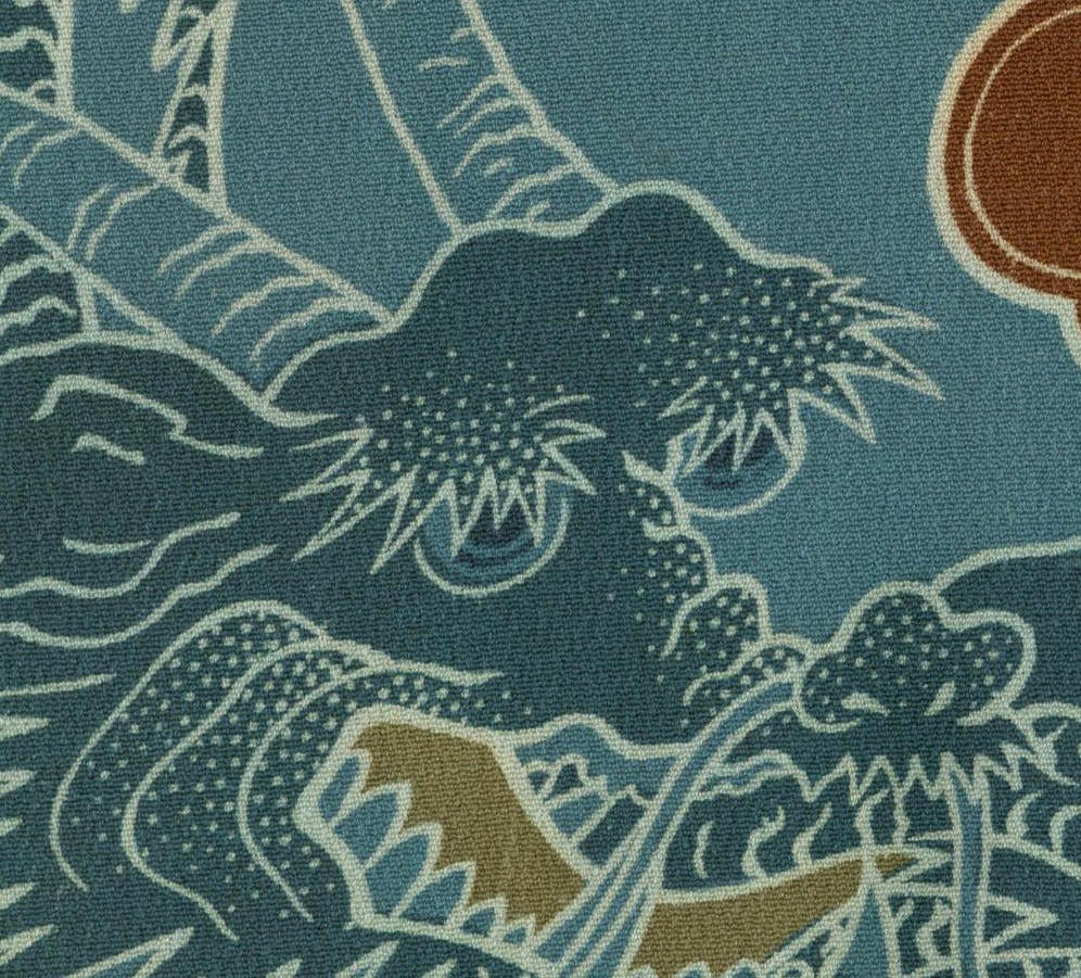 Textured fabric with stylized blue and green wave-like floral pattern