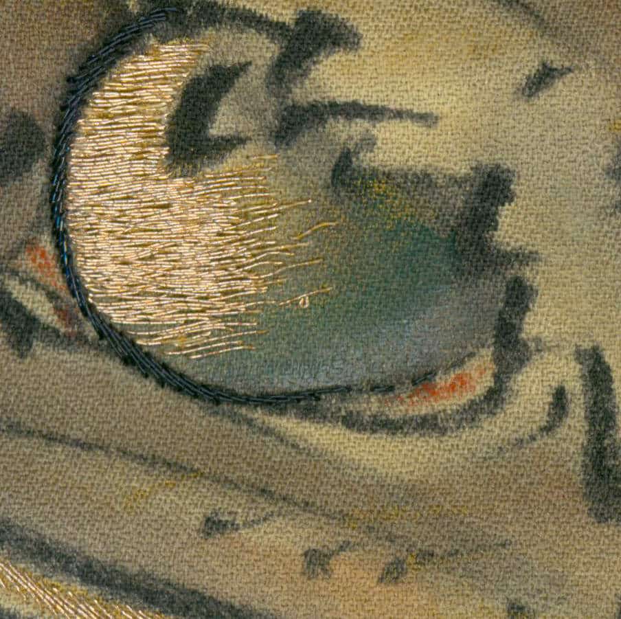 Golden embroidered curve on textured fabric with muted background