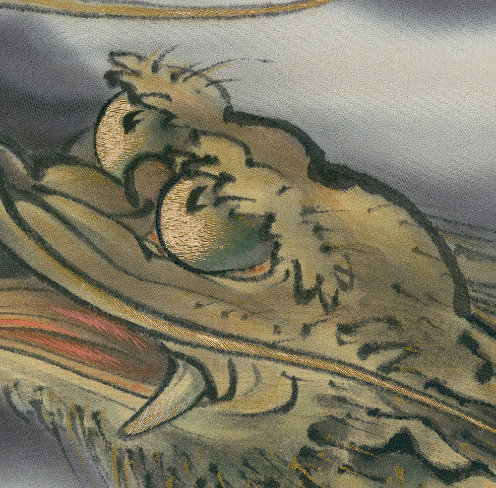 Embroidered abstract landscape with textured golden and gray tones