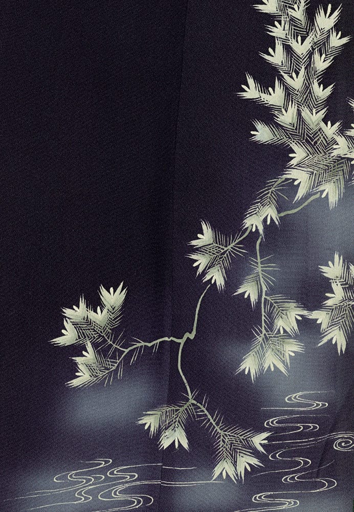 Delicate bamboo branches against dark background with flowing water lines