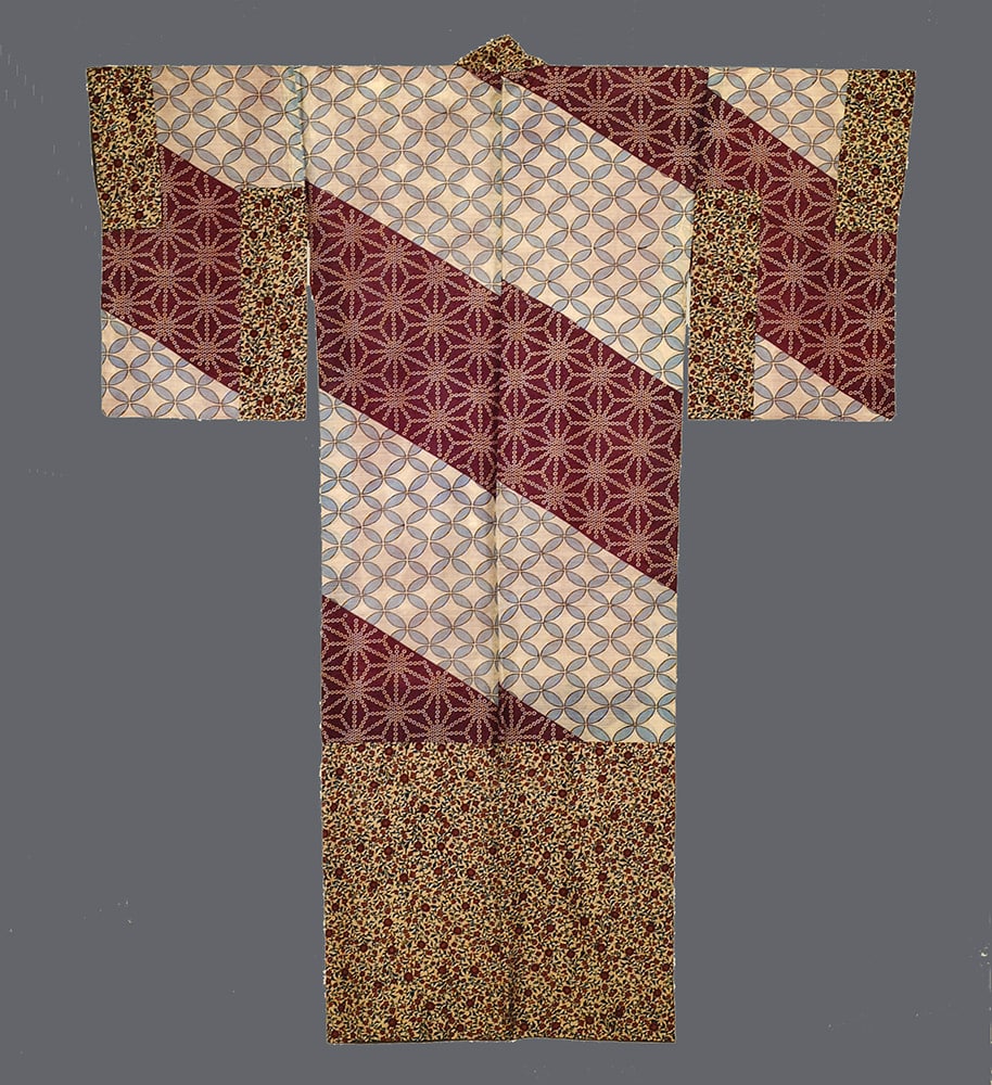 Traditional Japanese kimono with geometric patterns in burgundy, cream, and gold
