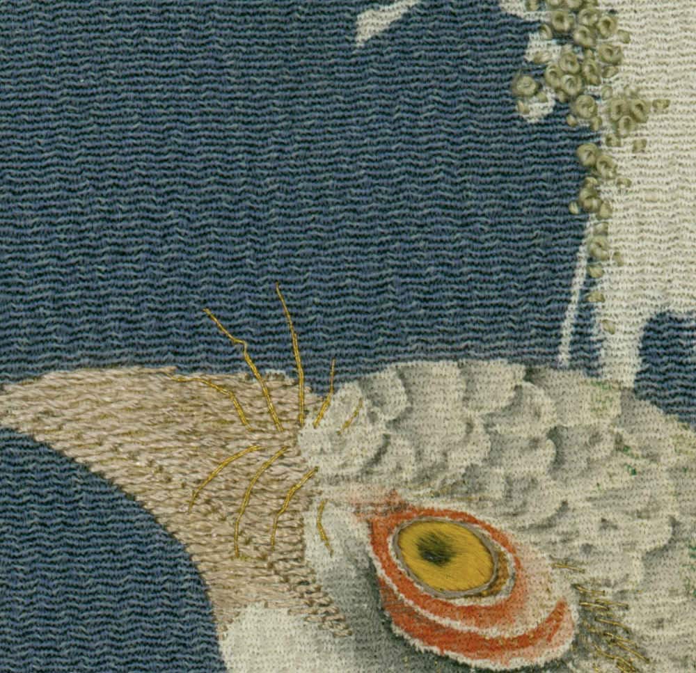 Detailed textile artwork with textured eye and organic shapes