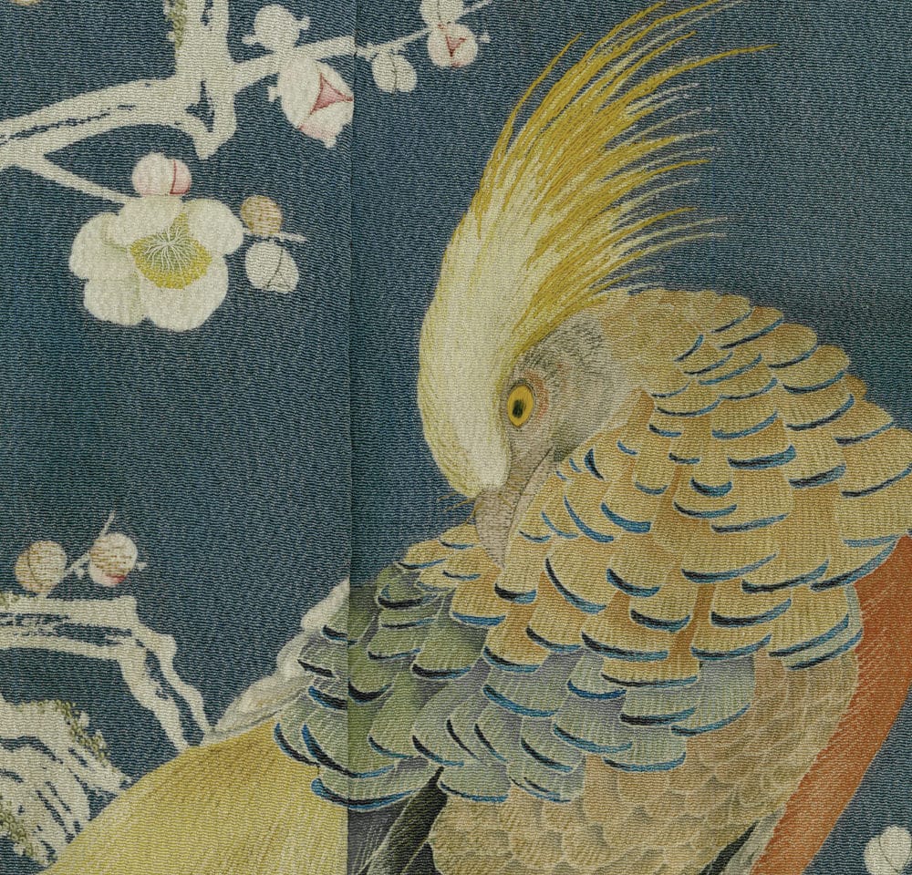 Vintage Japanese textile detail with golden bird and white blossoms
