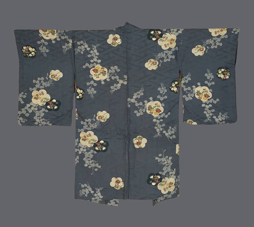 Traditional Japanese kimono with delicate floral pattern on dark gray background
