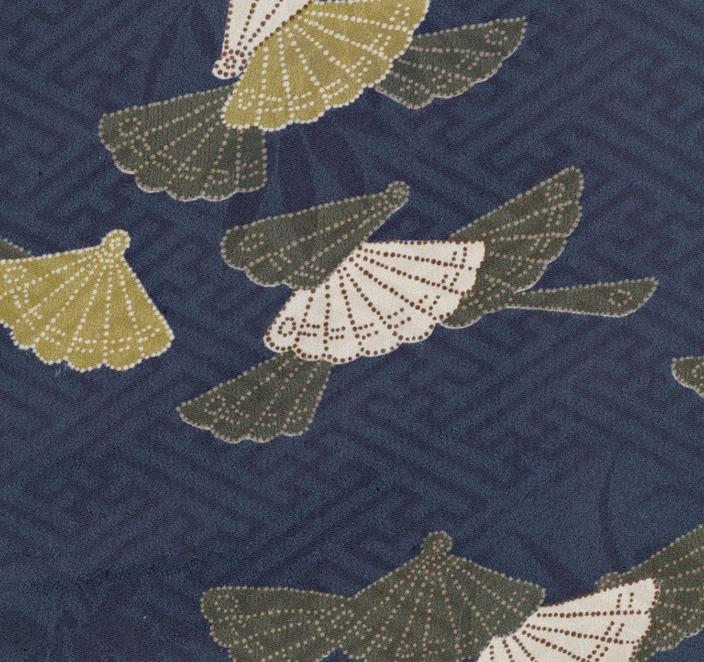 Decorative fan-shaped leaves on textured navy blue background
