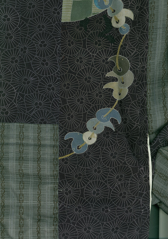 Abstract floral motif with stylized blue and green shapes on textured background