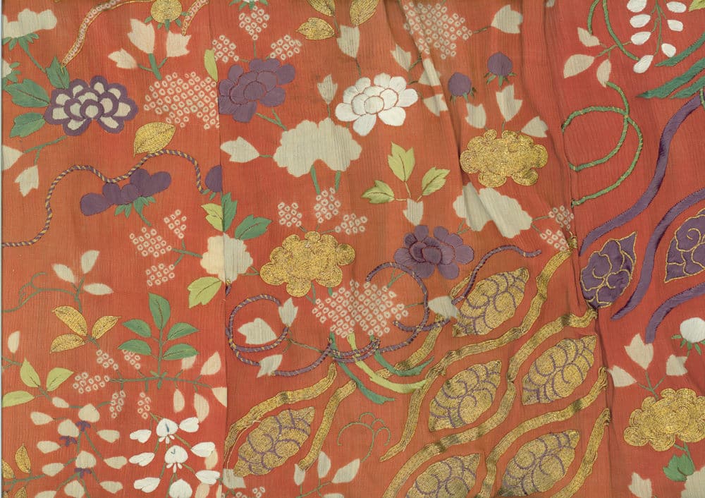 Vintage floral textile with orange background, golden and purple flowers