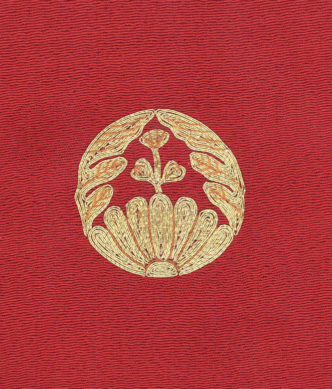 Golden floral emblem on textured red background with symmetrical design