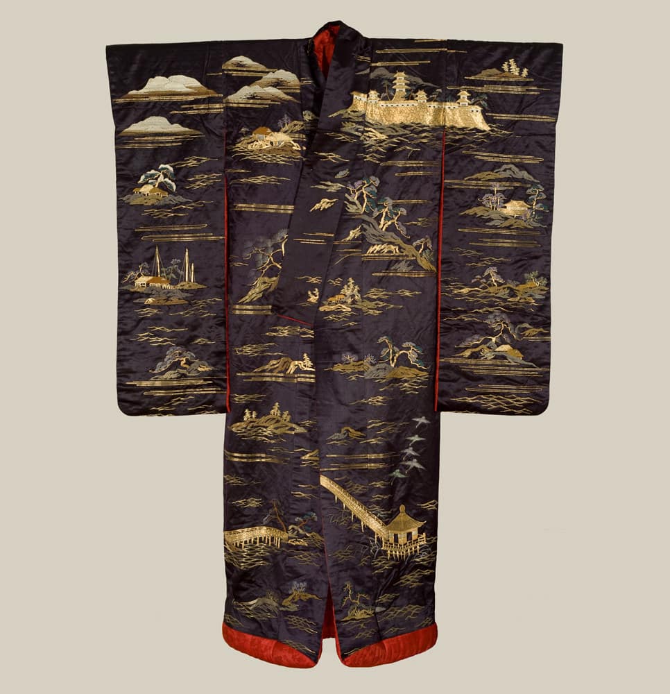 Ornate Japanese kimono with gold landscape scenes on dark background