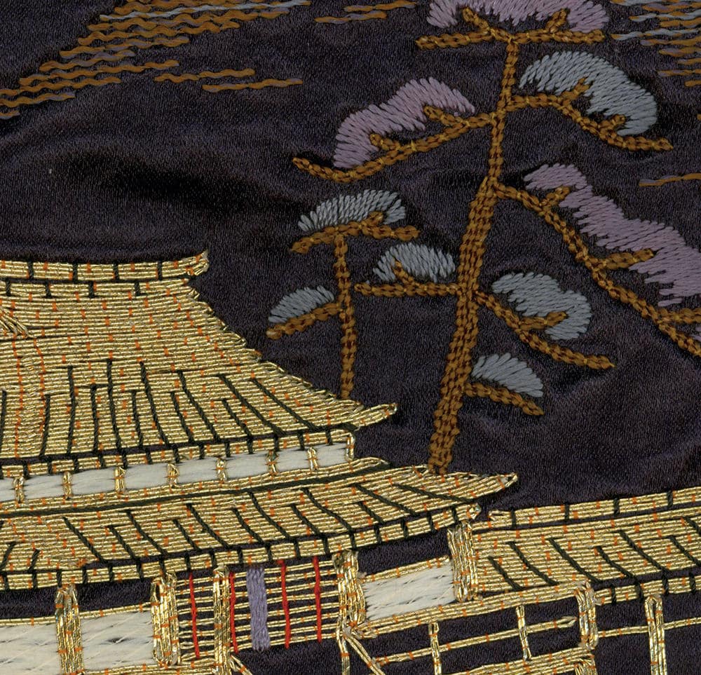 Intricate Japanese embroidery of golden pagoda and stylized tree branches