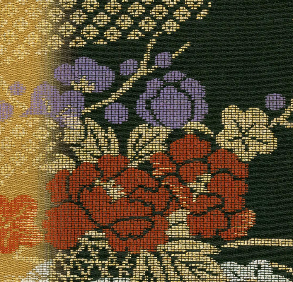 Textile with stylized floral pattern in red, purple, yellow, and green