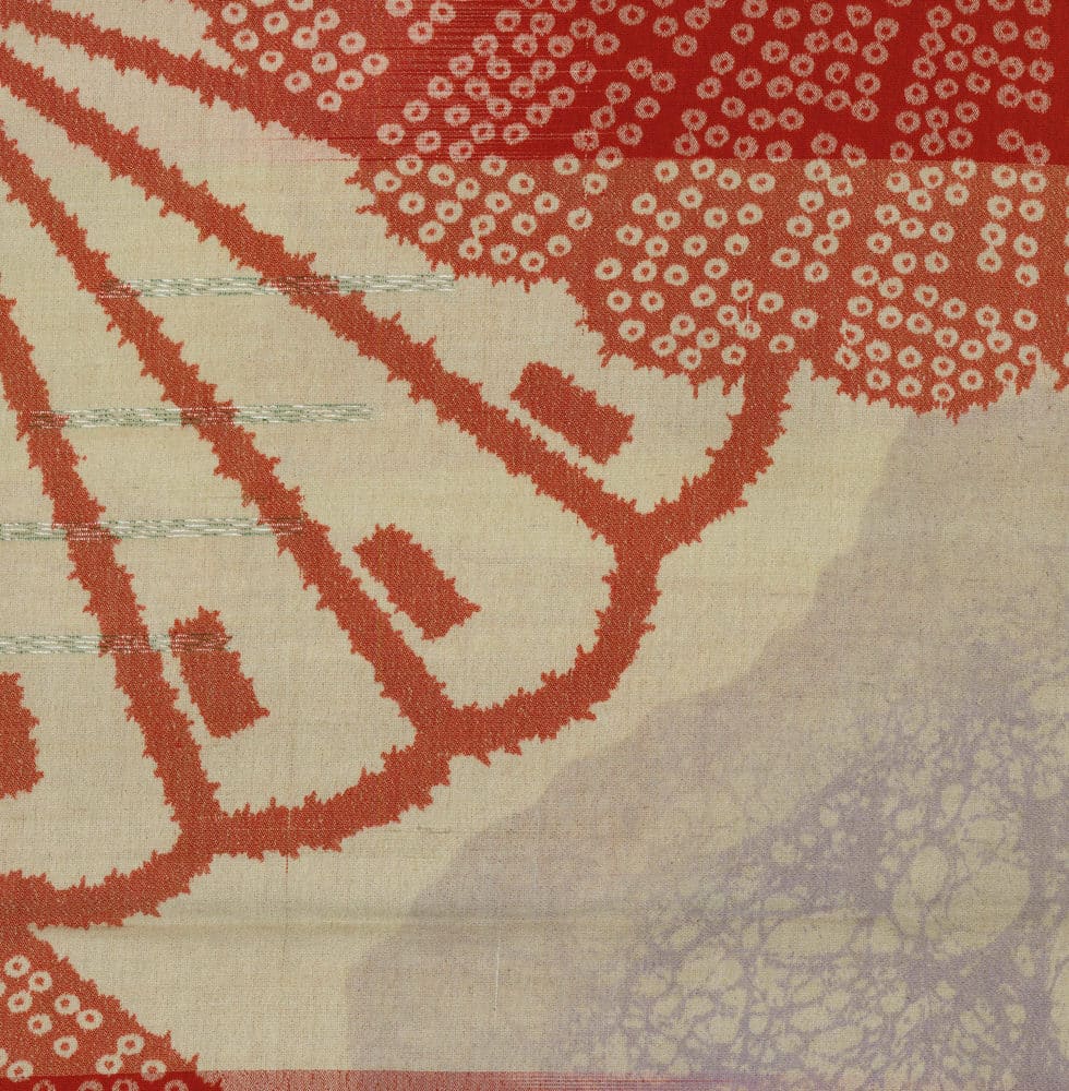 Red and beige abstract textile with organic patterns and dotted texture