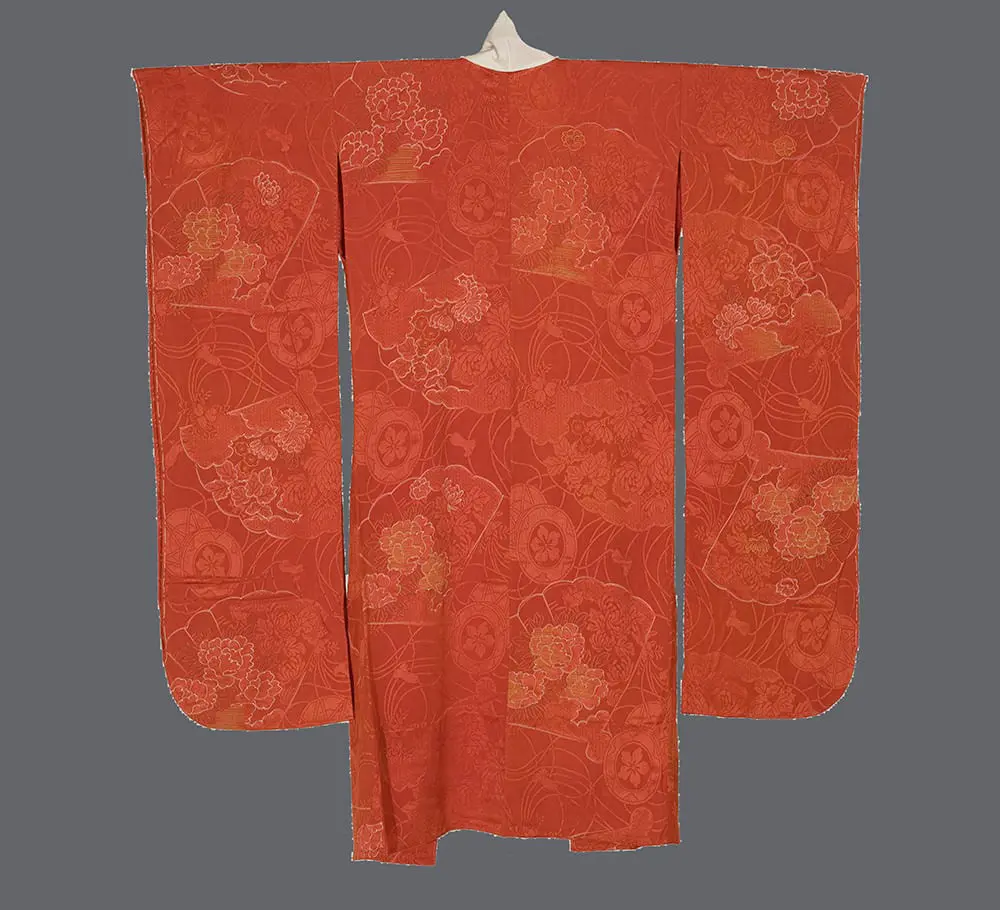 Coral rinzu silk juban featuring woven fans and tsuzumi drums with a white embroidered lapel.