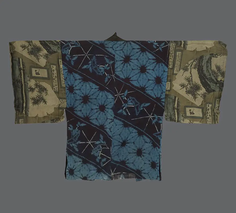Silk hanjuban with deep‑indigo shibori bodice featuring white dotted star motifs and printed sleeves with bamboo and text panels in muted Art Deco tones 