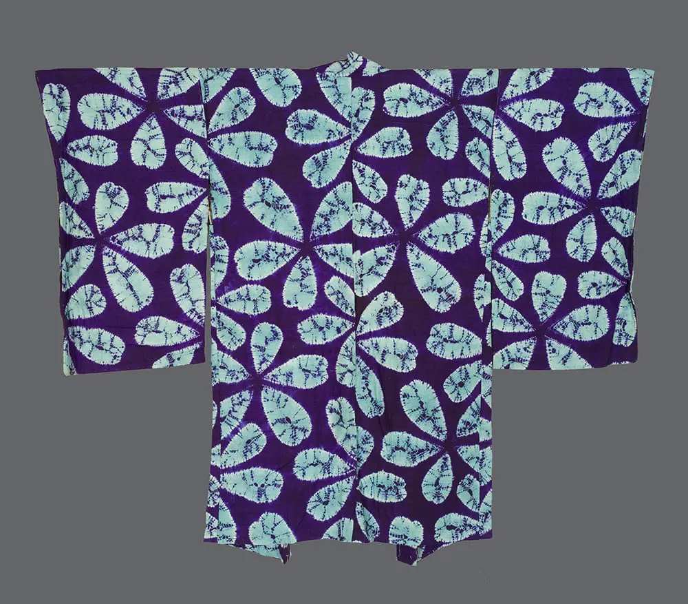 Silk haori with pale blue‑green shibori‑dyed leaf forms on a rich purple ground, showing radiating textures, hand‑spun irregularities, and Mingei‑influenced design 