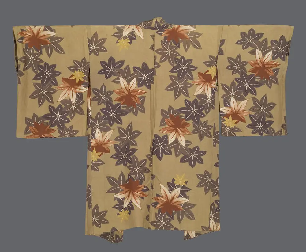 Sandy-ochre chirimen silk haori featuring large brown, orange, and yellow silkscreened maple leaf motifs.