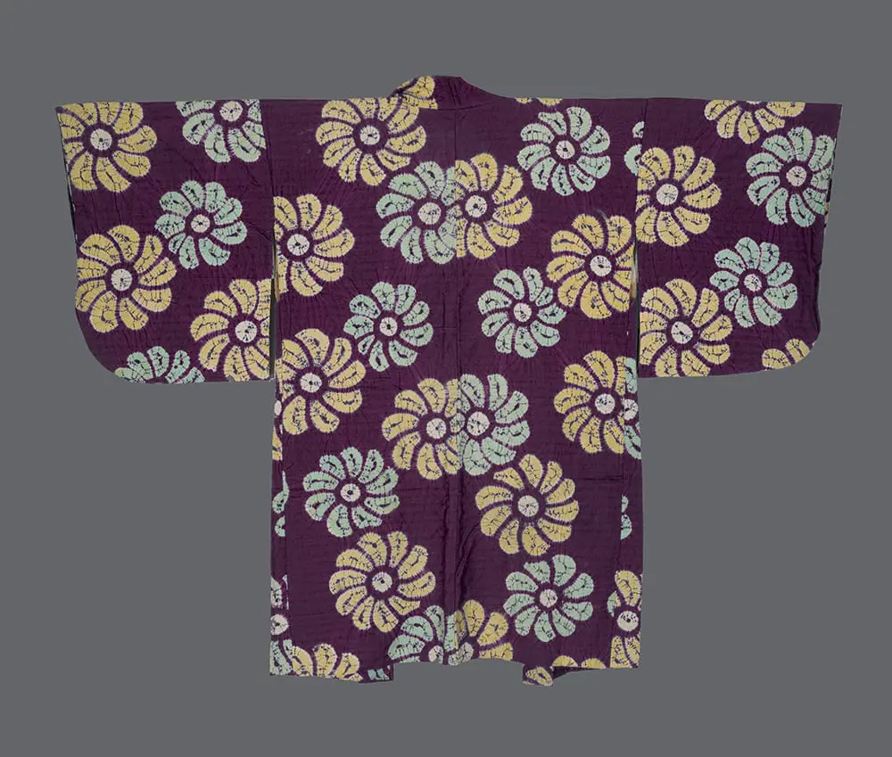 Plum-purple silk haori with large-scale shibori-dyed yellow and mint-green floral blossoms scattered across the back.