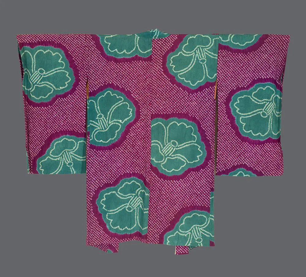 Magenta-purple shibori silk haori featuring large teal-green camellia flowers with white resist-dyed outlines.
