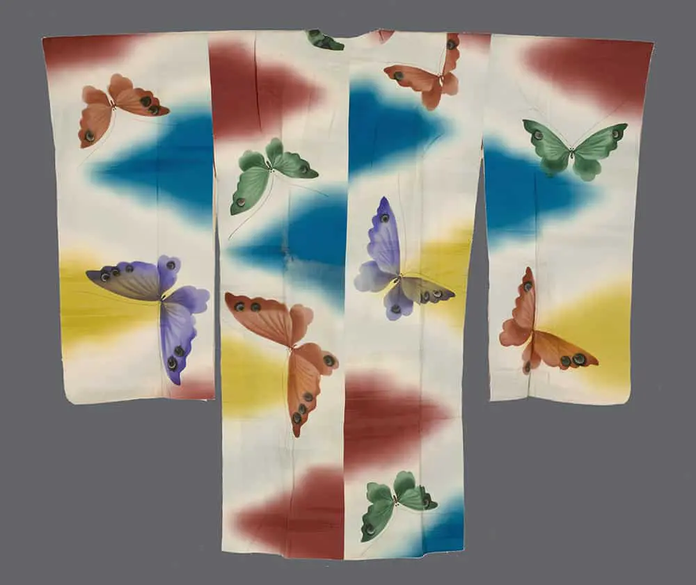White rinzu silk haori with large purple and green butterflies over bold blue, yellow, and red airbrushed clouds.