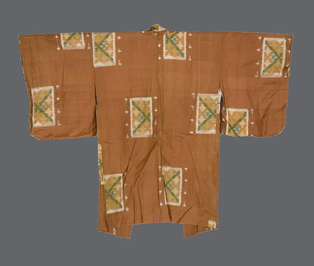 Terracotta-brown meisen silk haori from the 1950s with rectangular ikat patterns of green and orange diamonds.