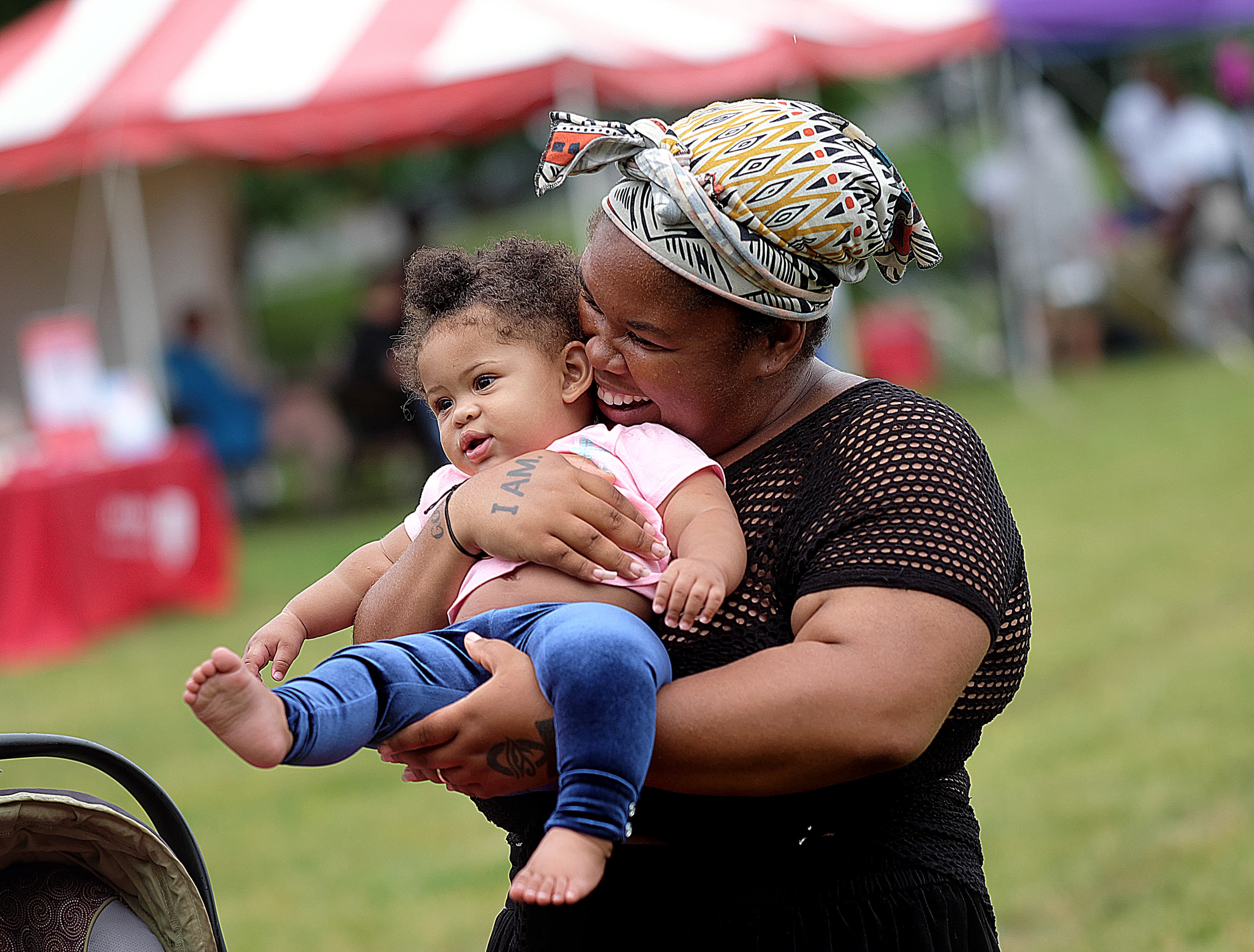 Joyful woman smiling holding baby