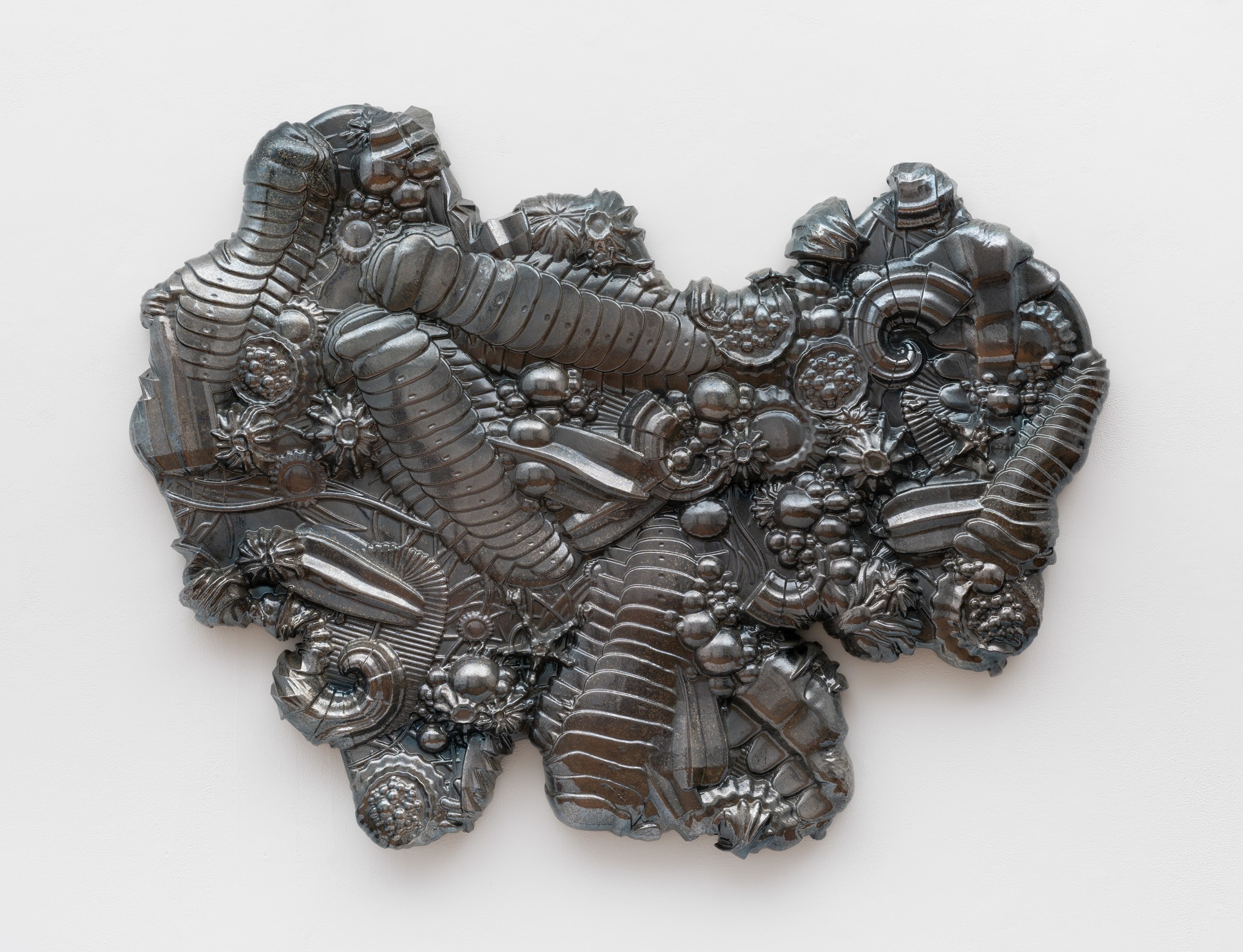 A wall sculpture of precambrian forms in gunmetal chrome