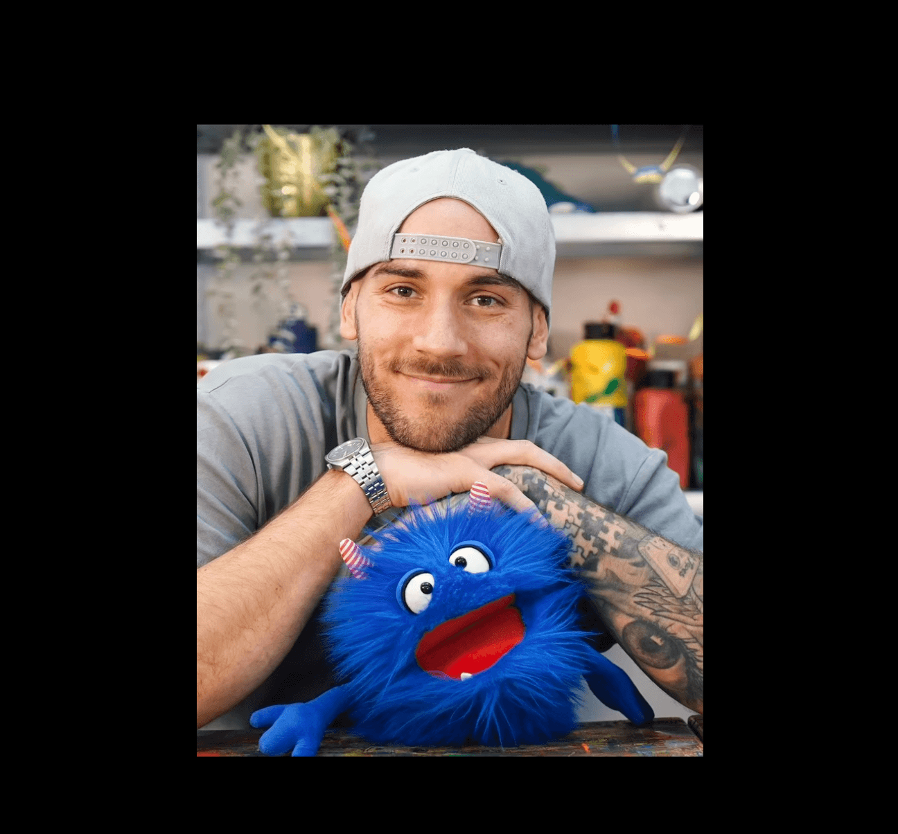 Portrait of a smiling skater men with a furry blue.