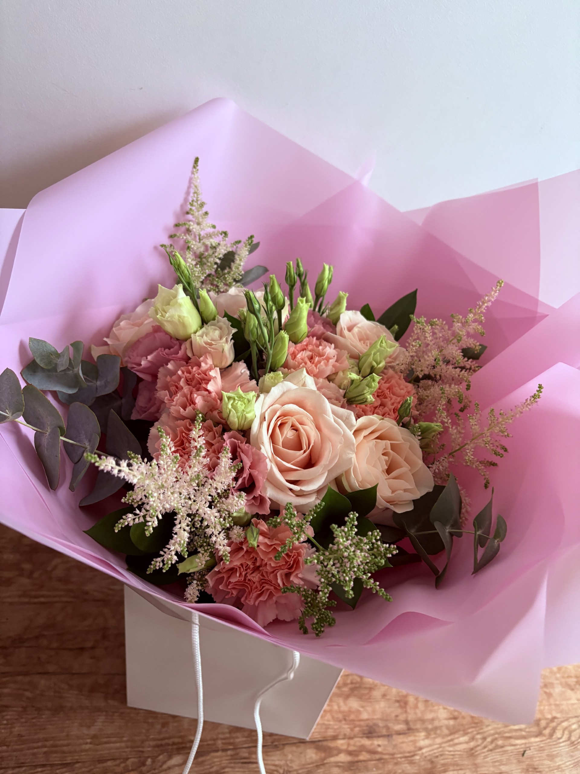 This pretty in pink posy contains roses, lisianthus, carnations, astilbe and foliages.