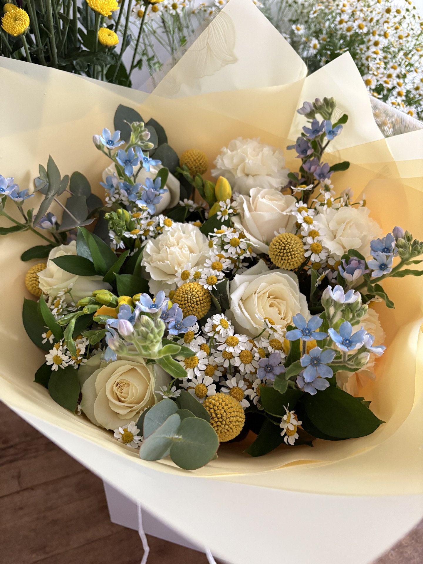 Avalanche roses, tweedia, craspedia, tanacetum daisies, freesia, carnations and foliage make up this sweet-scented, spring bunch.