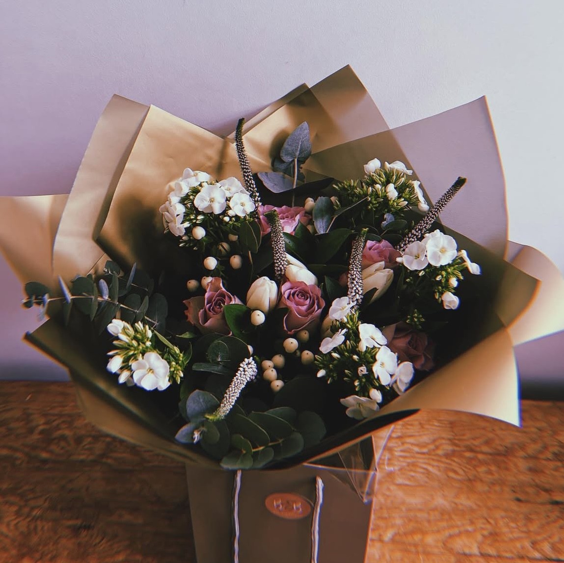 With violet roses, pale white hypericum, tulips, veronica and foliage, this pretty posy is the perfect present for you or your loved ones.