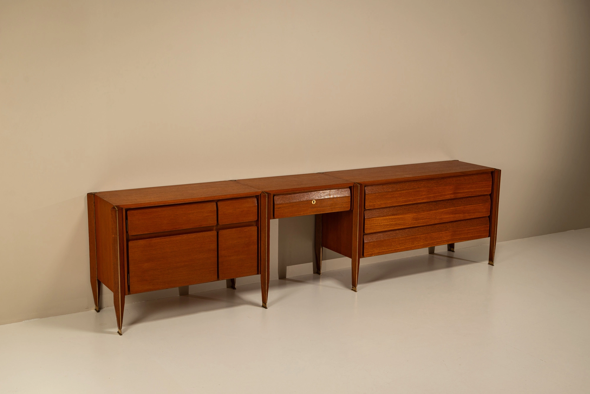 Four-door wooden cabinet with brass linear detailing