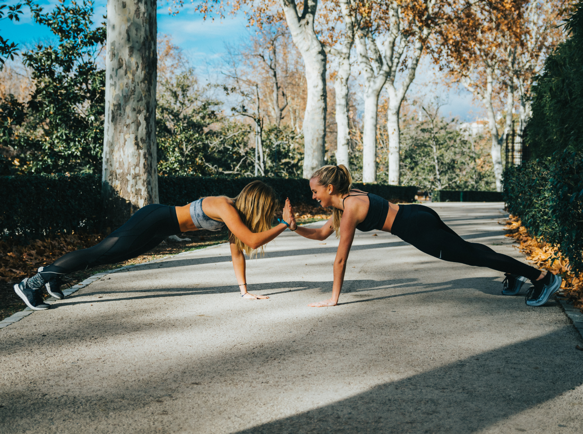 Women doing push-ups in a park