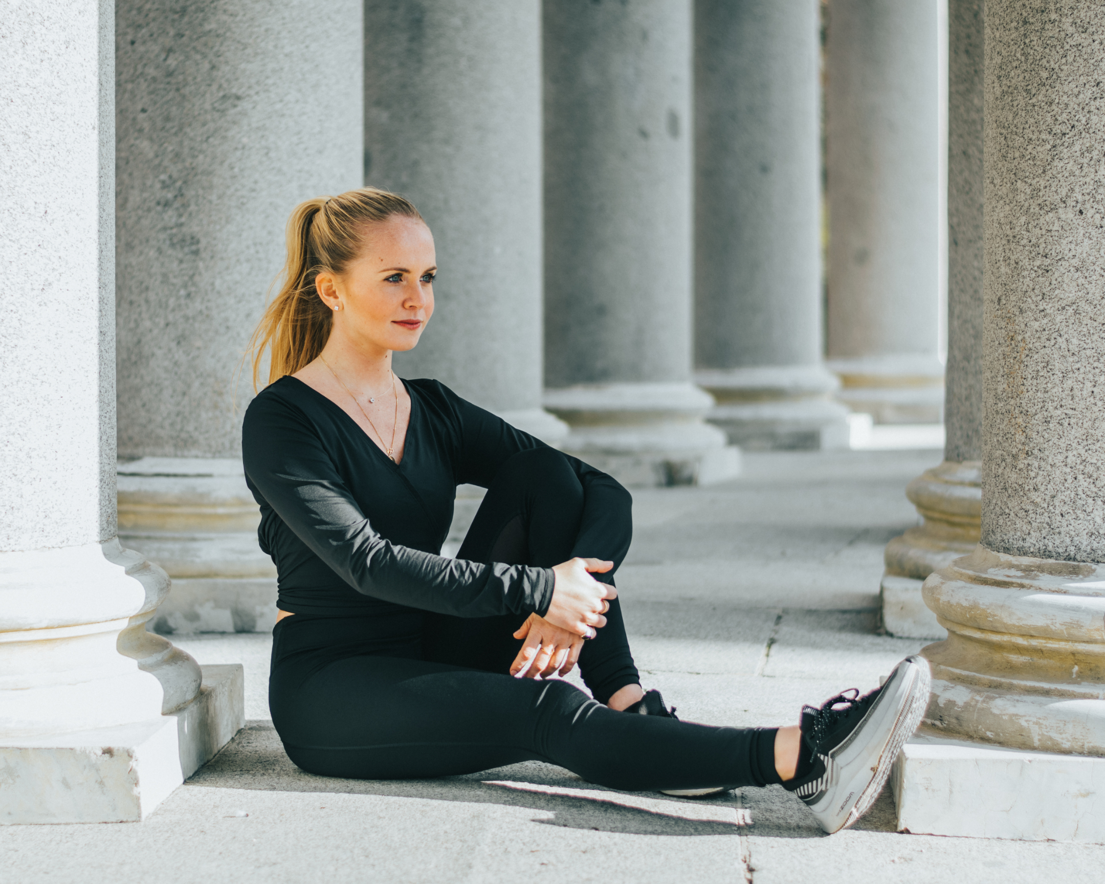 Fitness woman resting next to a column