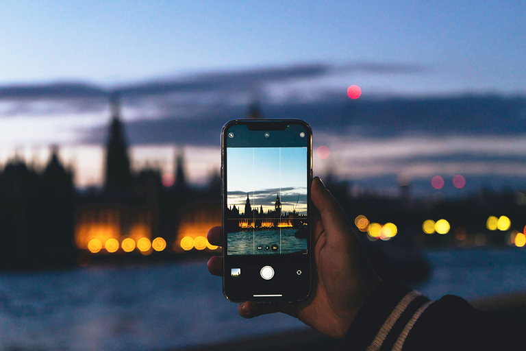 A close up view of a phone open to the camera app - the user is taking a photo of London.