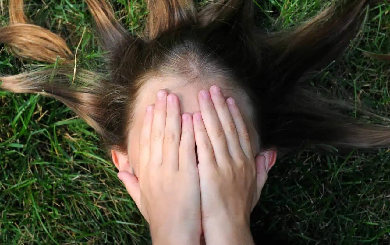 woman covering her face