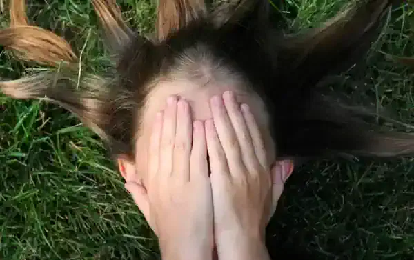 woman covering her face