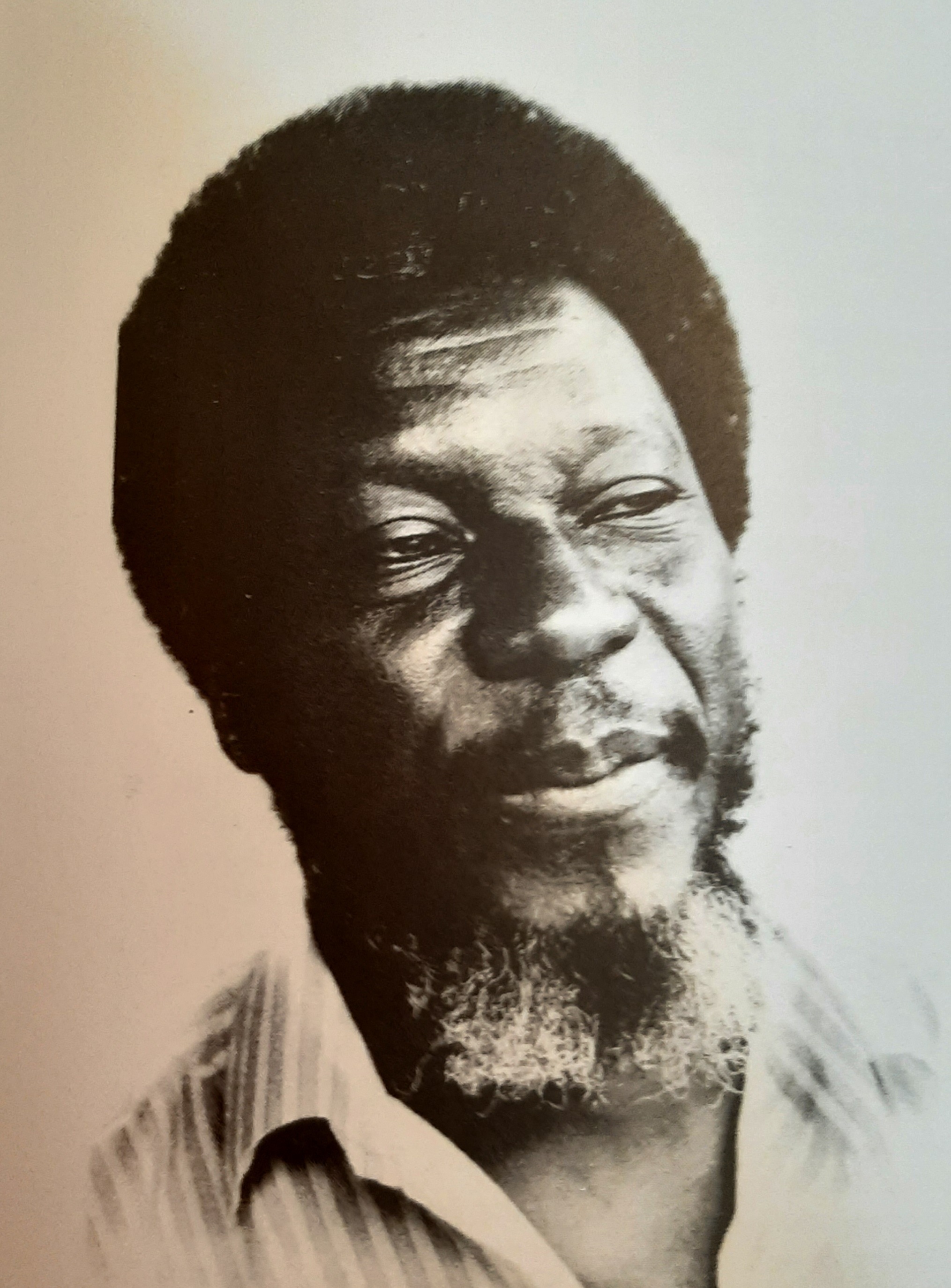Black and white photograph (headshot) of Abdul Malik