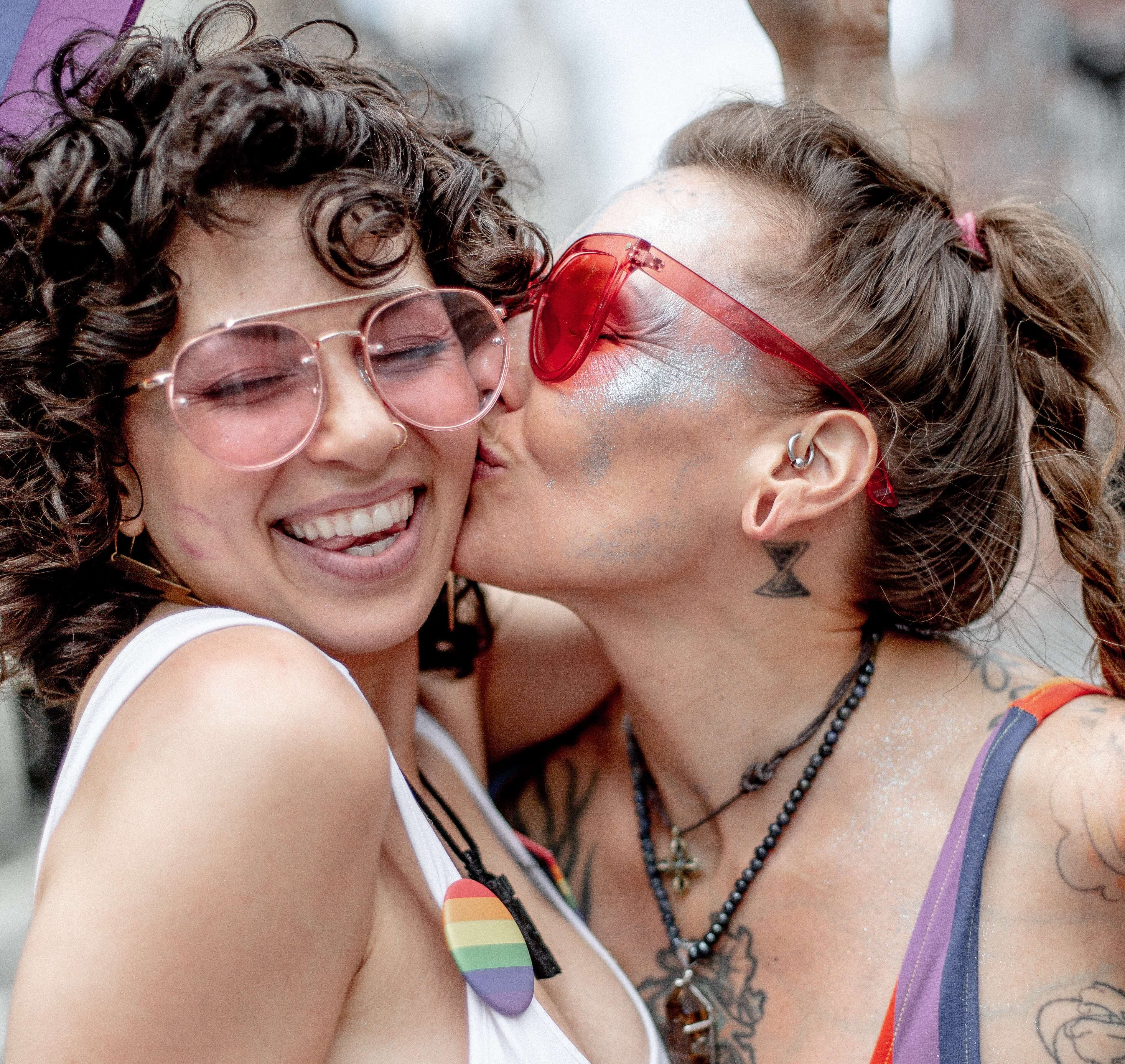 Attractive couple of half black half Caucasian man with his arm around a Caucasian woman with long brown hair smiling