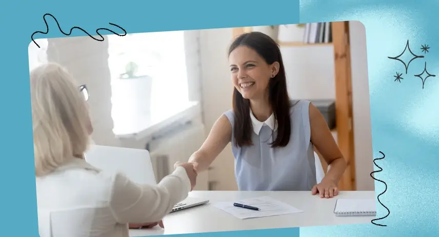 Image of a woman shaking hands with her boss.