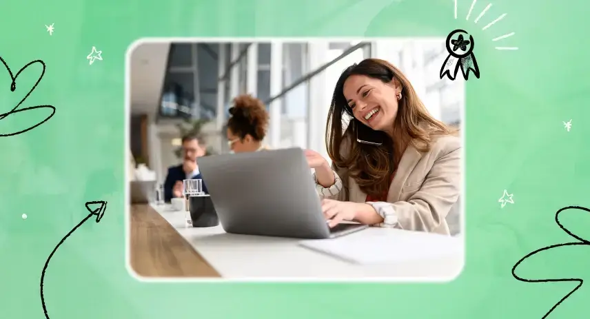 A smiling woman with a laptop in the workplace.