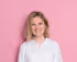 Portrait photo of Emily Hinks on a pink background