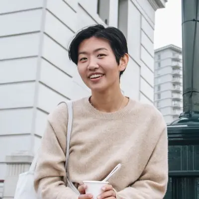 photo of Yen Tan in white shirt against building