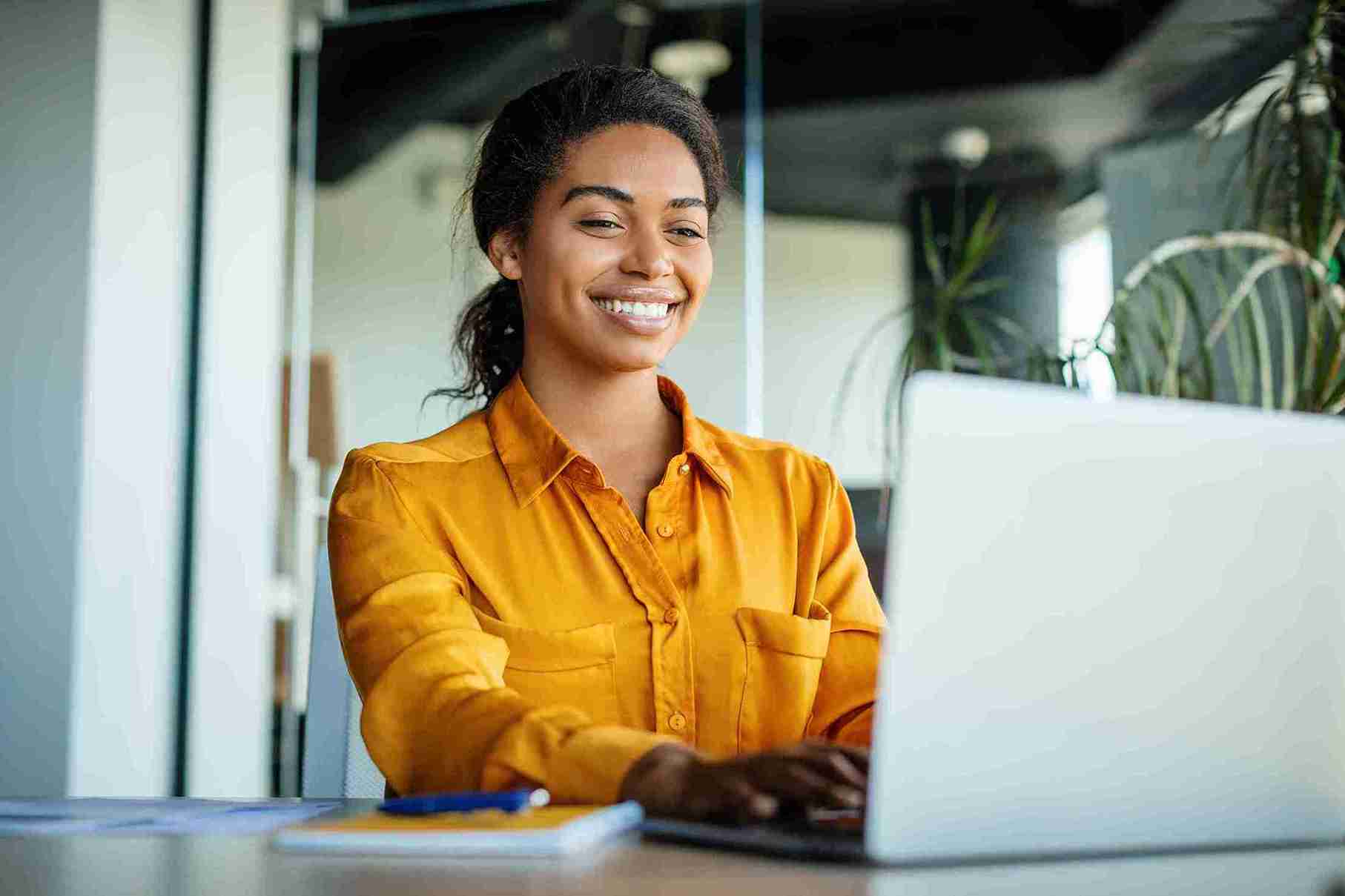 image of a smiling woman in front of a computer