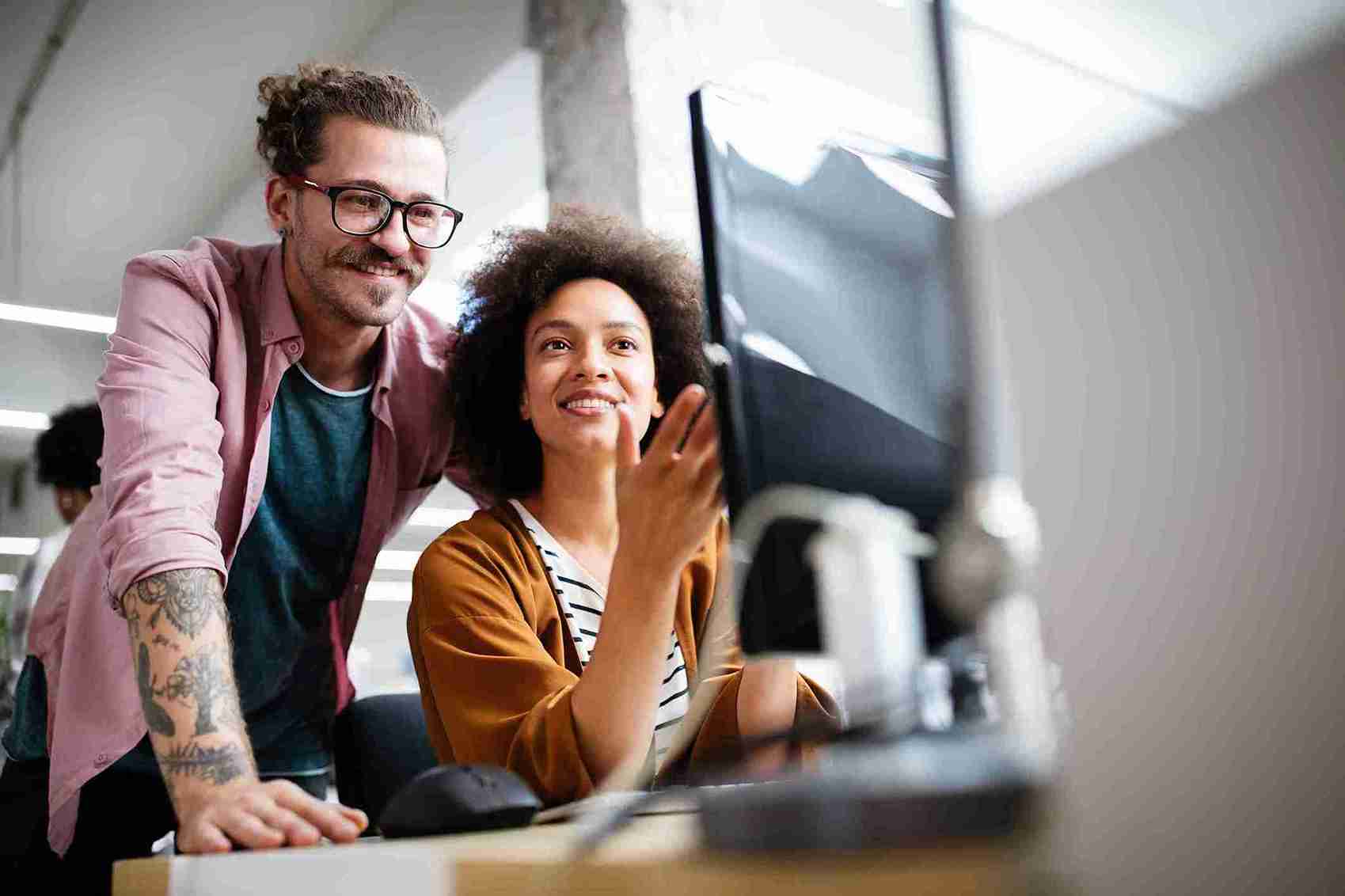 A image of people looking at a computer screen.