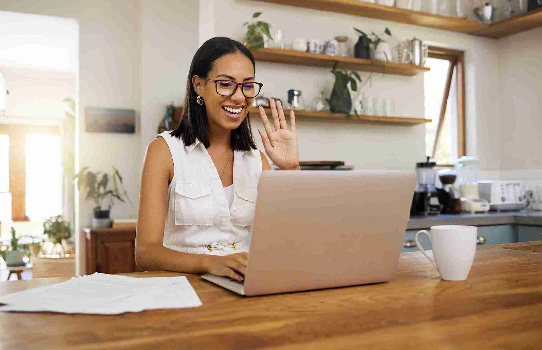 Woman smiling in front of her computer.