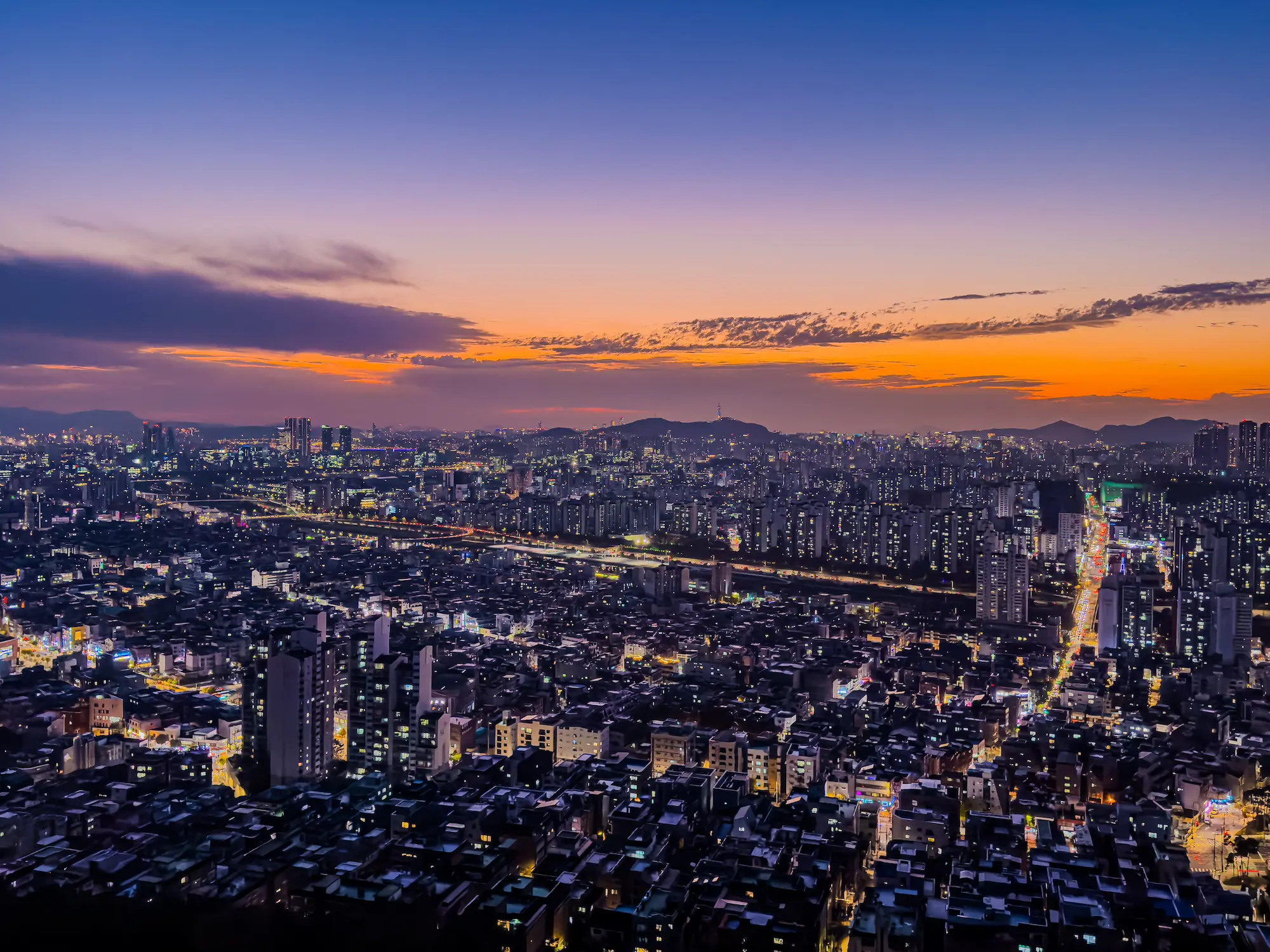 Seoul at sunset, showcasing vibrant city lights and skyline