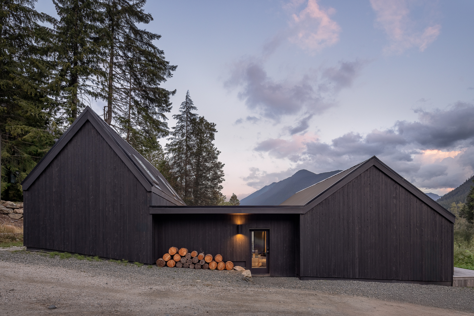 exterior view of twin gable building forms in natural landscape