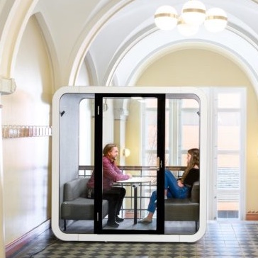 Two people working in a Spacehub pod