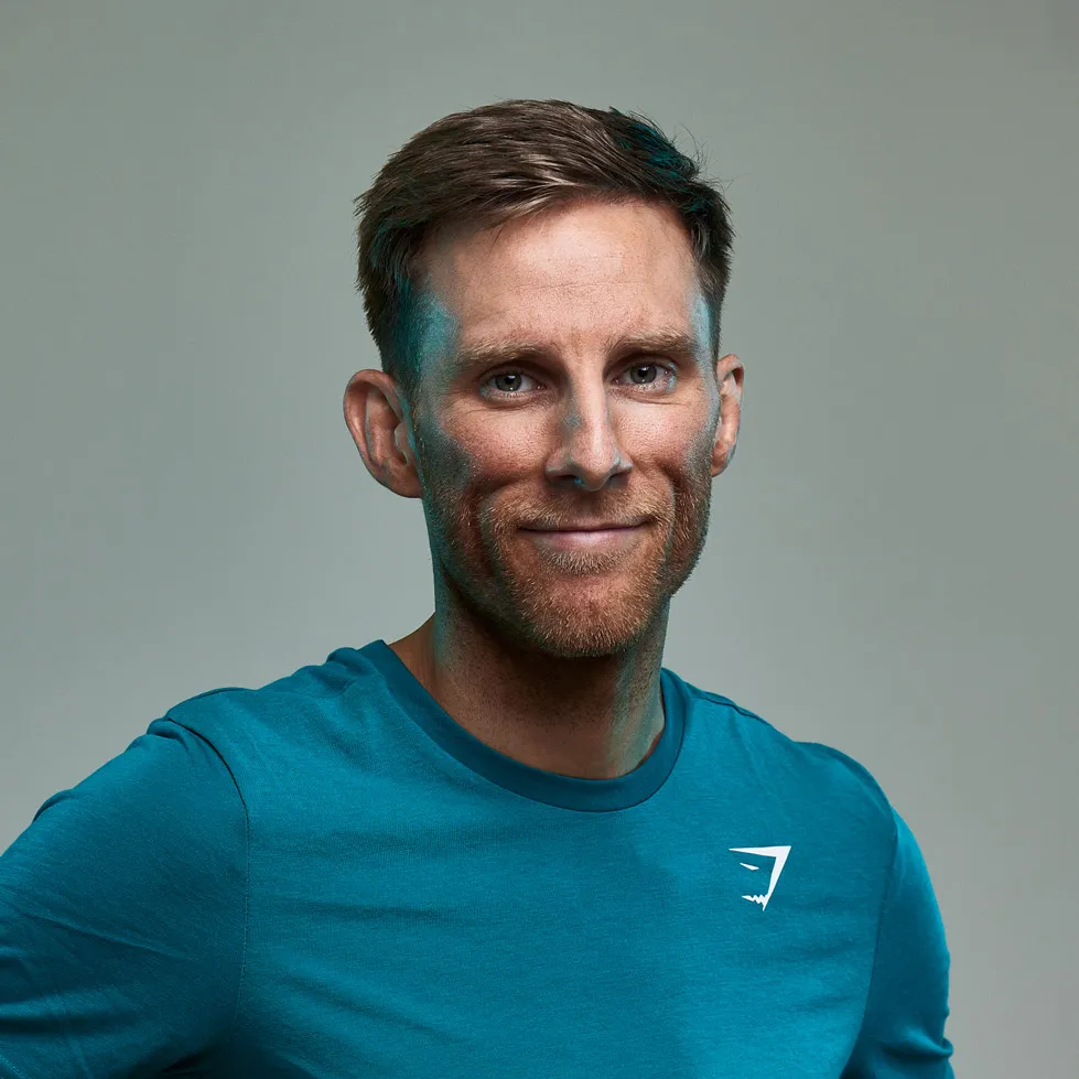 Kev Lawrence smiling, photographed in a studio