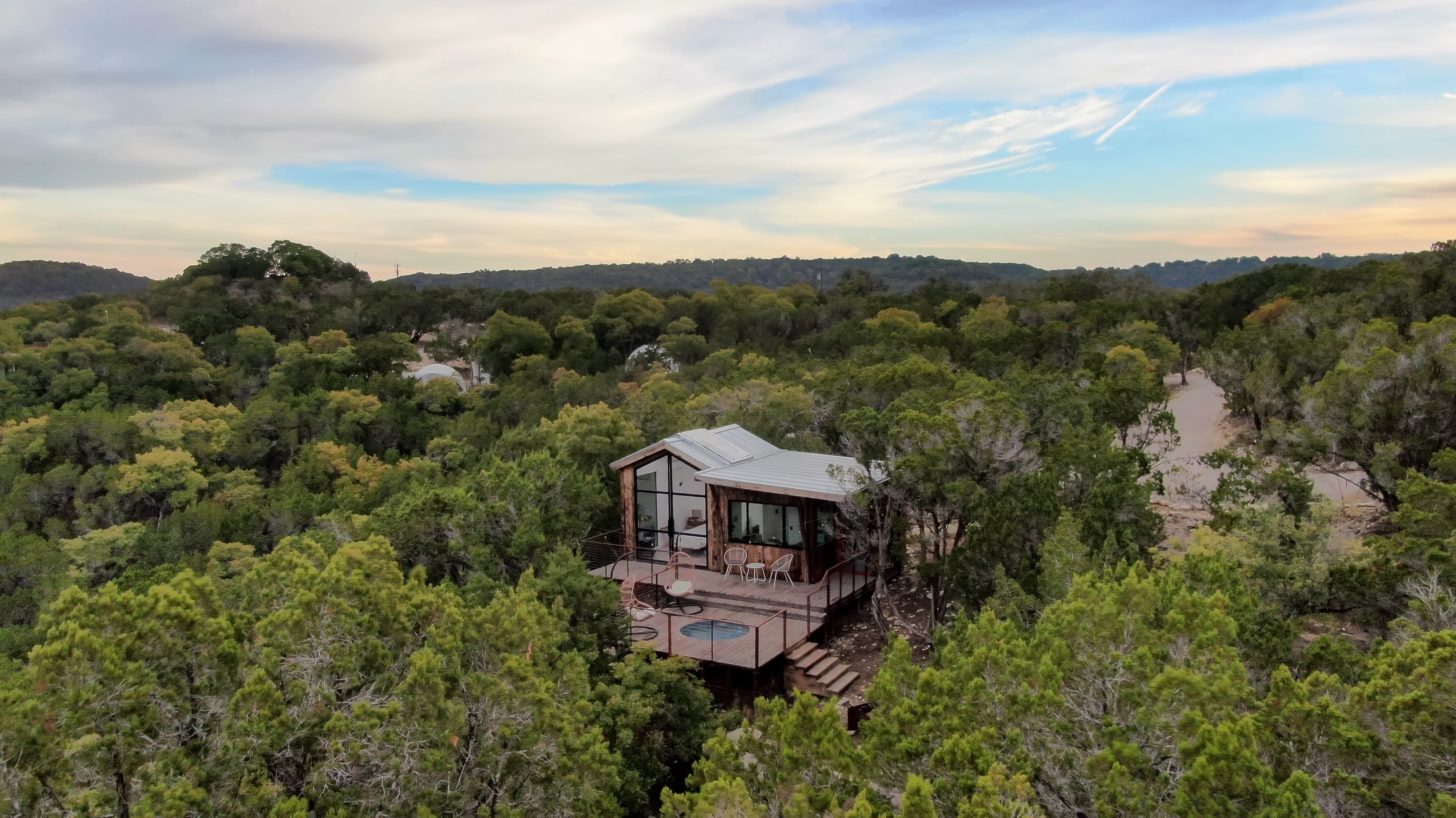 A treetop villa at MISSING, seen from above the Hill Country tree line
